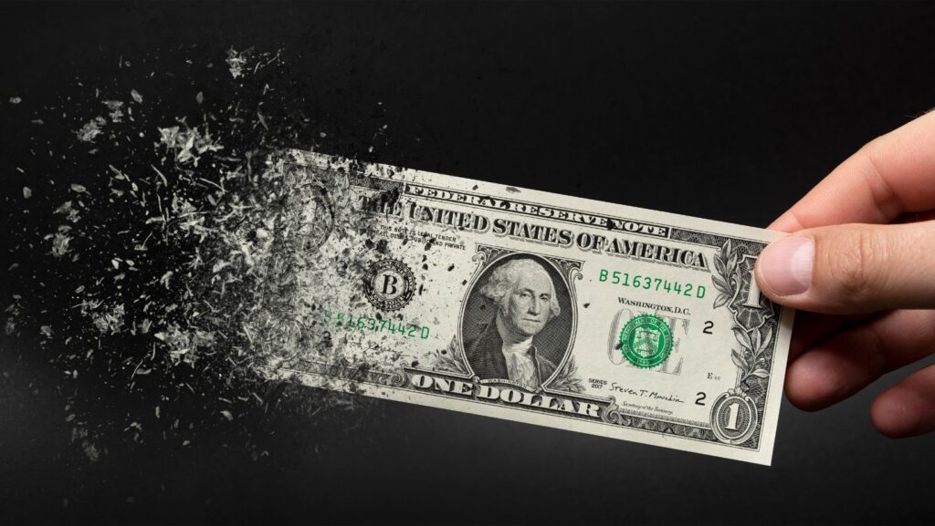 image of dollar bill dissolving into the air for the article "what will inflation be in 2030?"