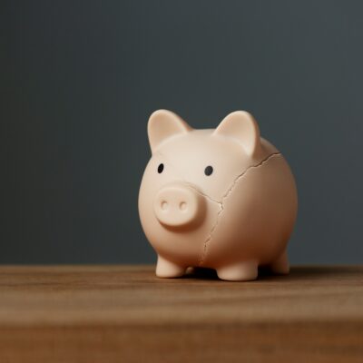 piggy bank on a desk for the article "the eight biggest mistakes investors make"